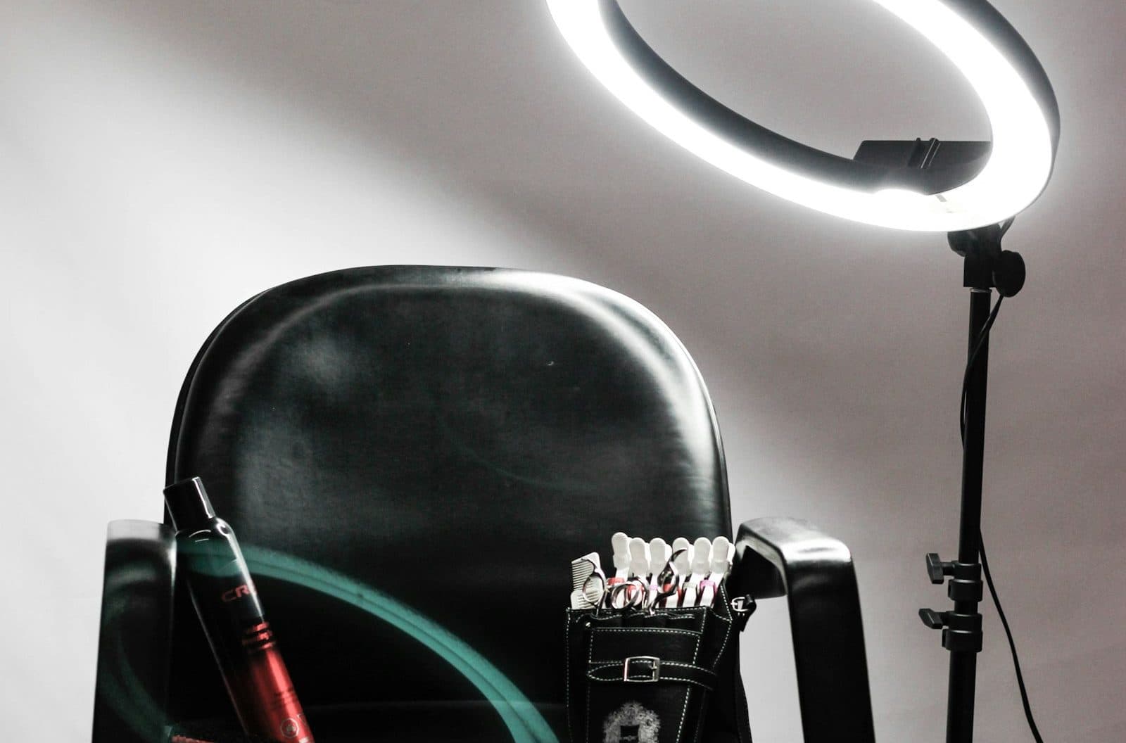 A ring light standing over a seller's chair and kit